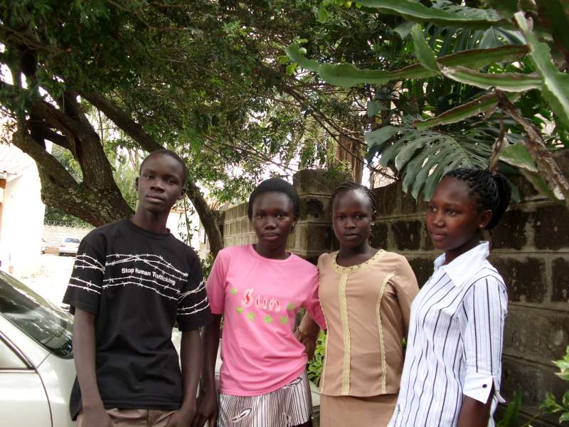 3 girls and 1 boy pose for the picture in Africa