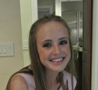 Alexandra Intriago_ 2014-2015 Teen Advisors (close angle headshot, picture little blurry) a teen girl wearing her white shirt with her smiley face facing the camera