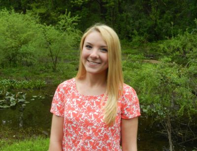 Becca Bean 2016-2017 Teen Advisors ( half-body pciture, blurry pciture) with her smiley face facing the camera and background is greenery