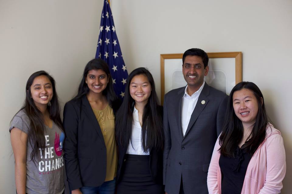 4 Girl Up girls picture with a district meeting