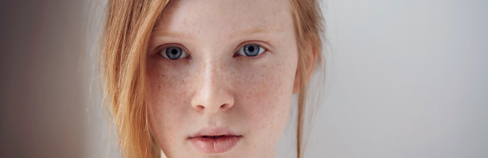 a very close cutoff shot of a Caucasian girl looking straight at the camera