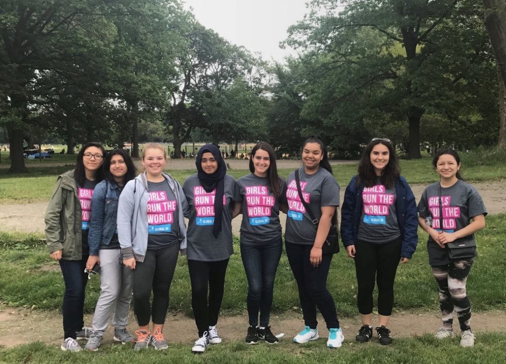 a group of different ethnic girl up girls pictures in the park wearing the t-shirt said "girls run the world"