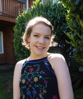 Lauren Woodhouse 2017-2018 Teen Advisors (headshot ) with greenery background