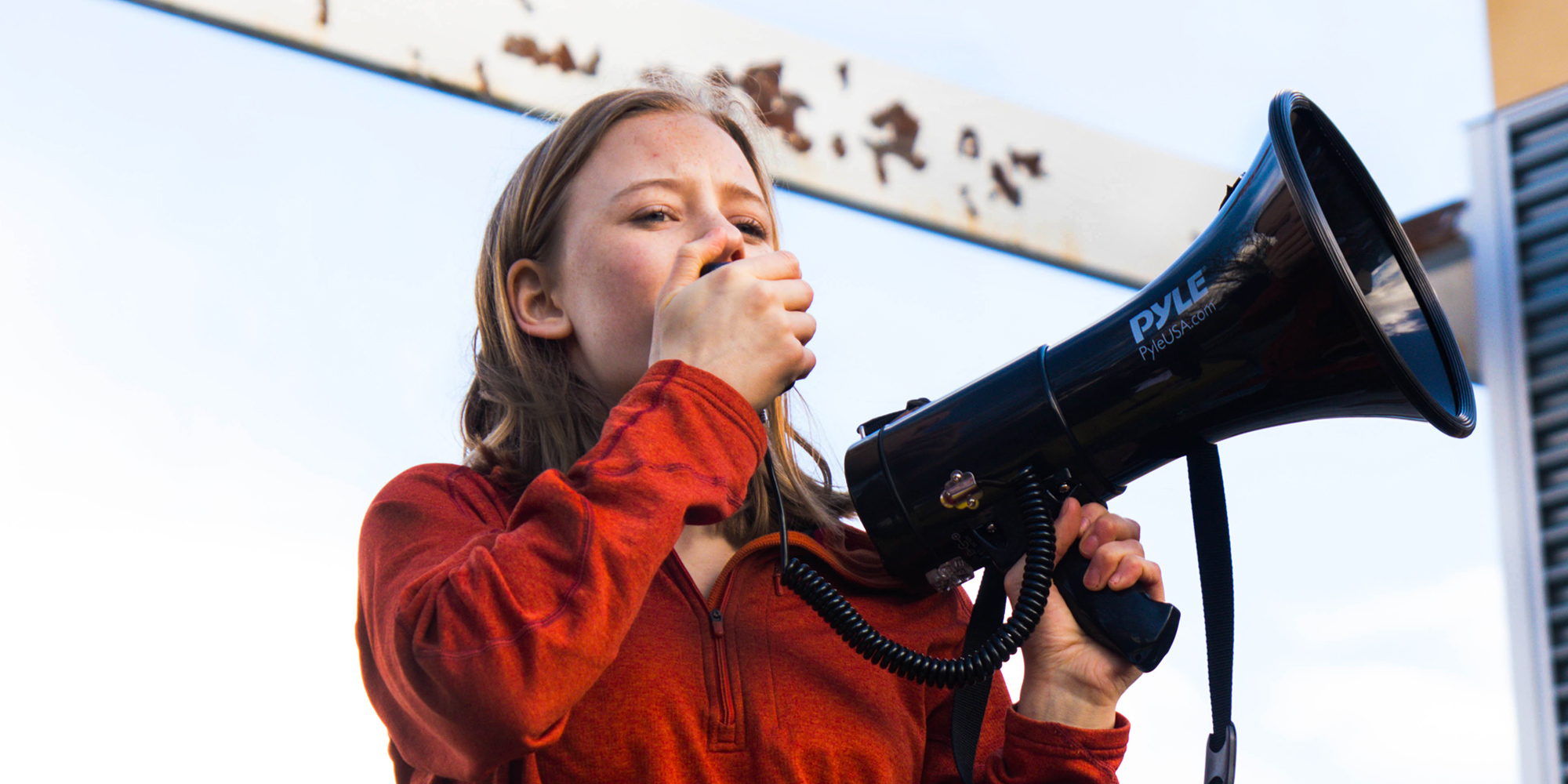 (close angle) Eva Jones 2018-2019 Class Teen Advisors holding a loudspeaker