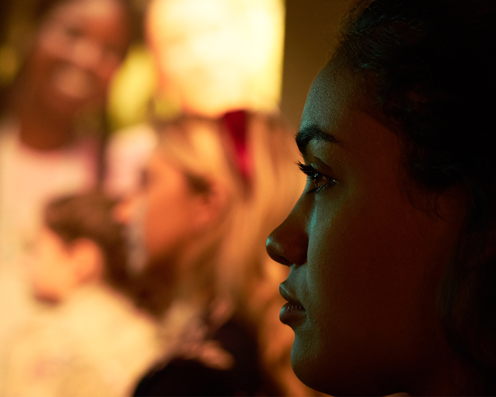 a half face of a girl face in the dark