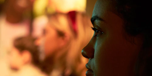 a half face of a girl face in the dark