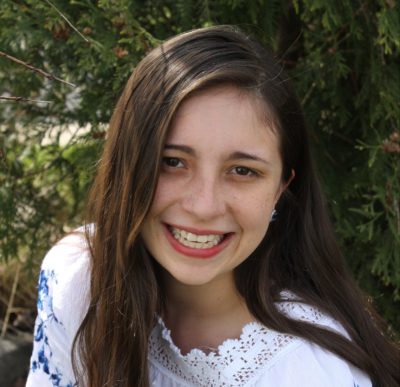 Maria Aldana_2016-2017 Teen Advisors (a very close headshot) with her smiley face facing the camera, with background greenery