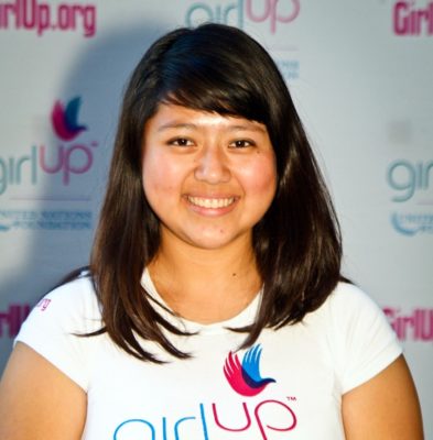 Rocio Ortega_Hometown: Los Angeles, CA_2011-2012 Class The second class of Teen Advisors (close angle headshot) a teen girl wearing her girl up white shirt with her smiley face facing the camera, and background is girlup.org board
