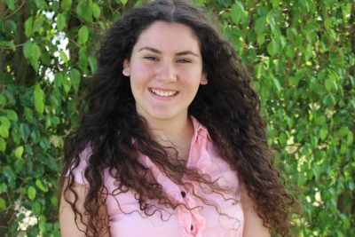 Shayla Zamora_2016-2017 Teen Advisors (close headshot, a little blurry) with her smiley face facing the camera,with background greenery
