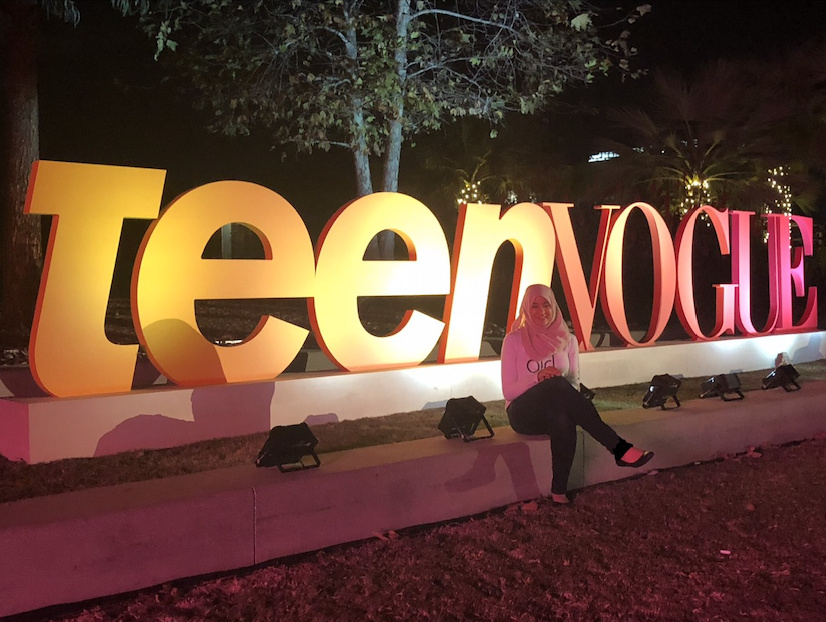 a girl up girl picture in front of the Teen Vogue sign