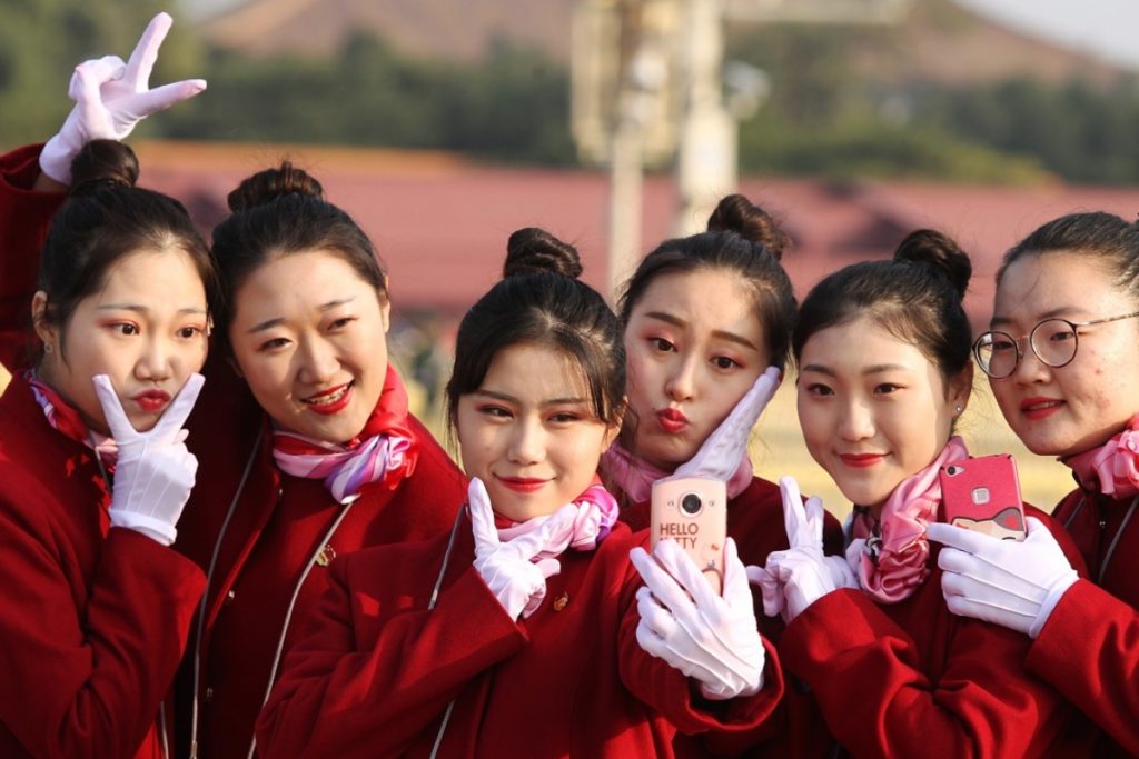6 girls wearing red and pose for their selfie