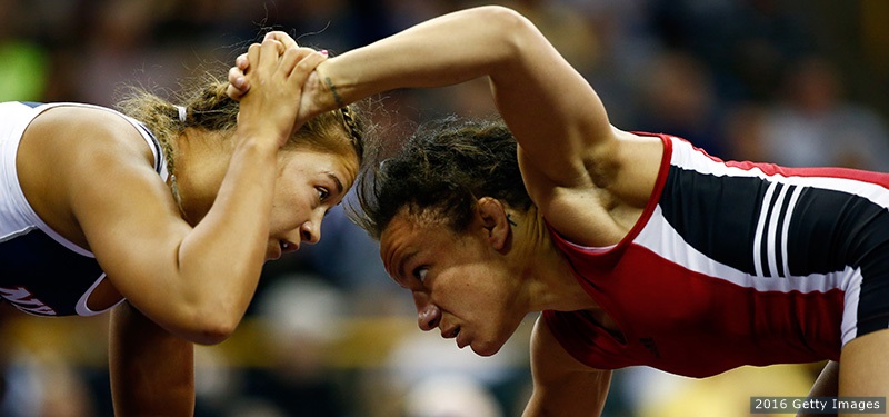(close angle) Campbell Kelsey is wrestling with other athletes