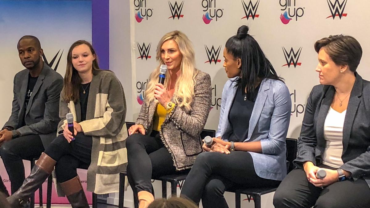 wwe-and-girl-up forum (5 people on the stage) WWE Superstar Charlotte is holding a mic facing to the front