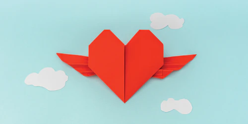 a paper folded heart with wings