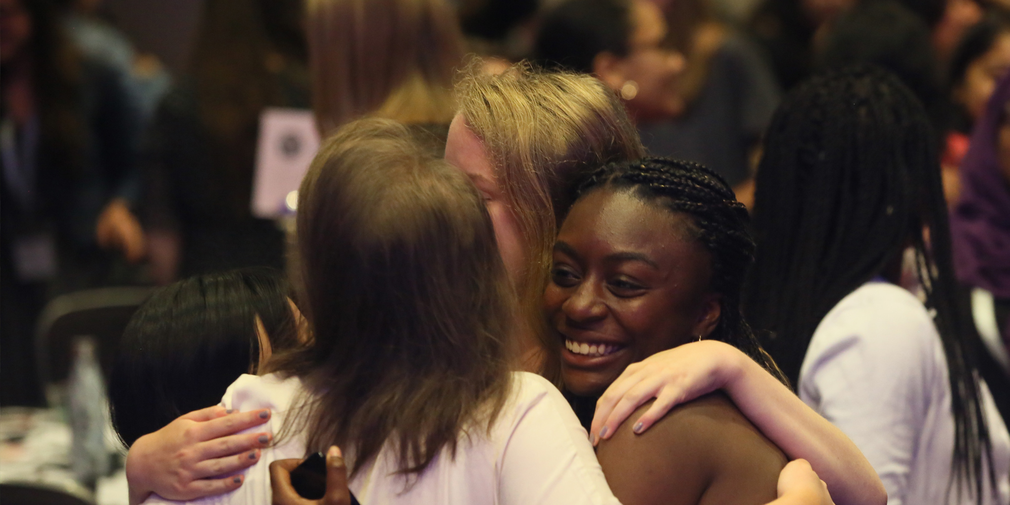 a group hug picture with 4 different ethnic Girl Up girls