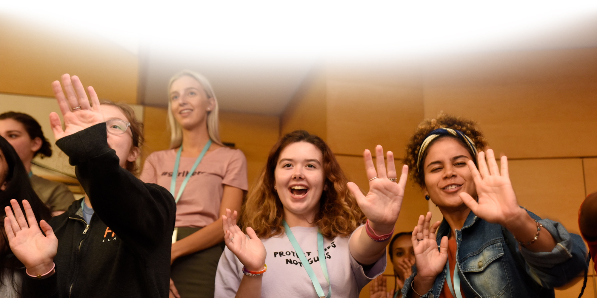 lower angle _3 girls with a big smile and are stretch their both hands out (iron man pose)