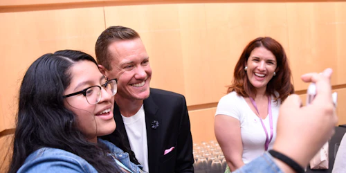 a teenage girl taking a selfie with a celebrity