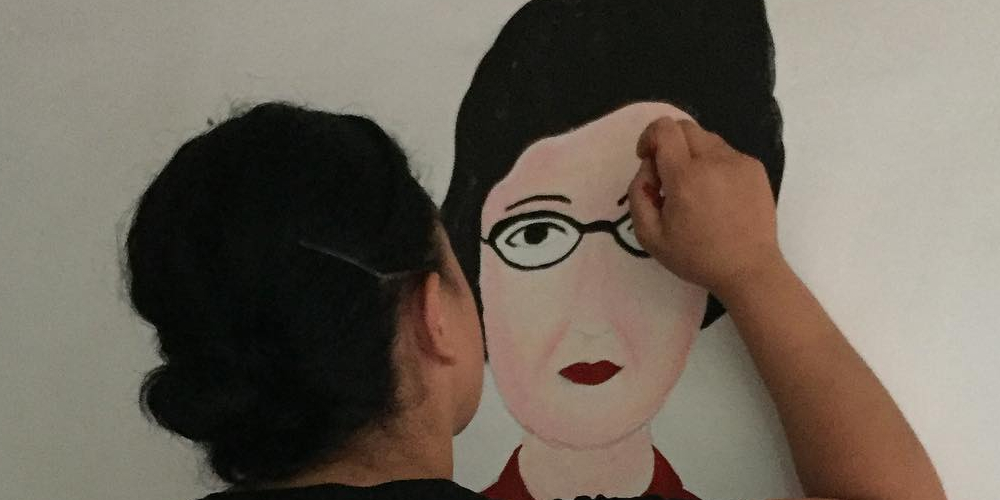 Artist paining portrait of Katherine Johnson